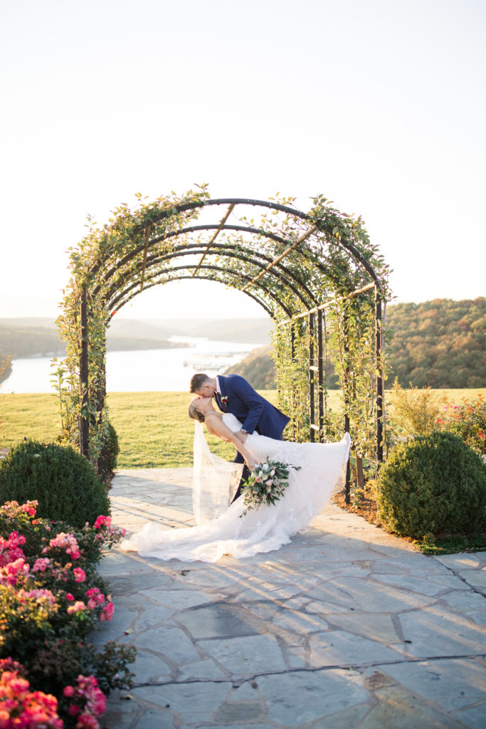 Couple kiss in garden at Integrity Hills Chapel in MO
